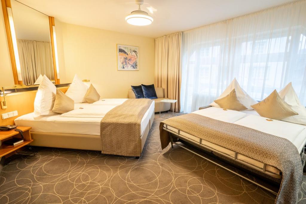 Postel nebo postele na pokoji v ubytování Hotel am Stadtgarten