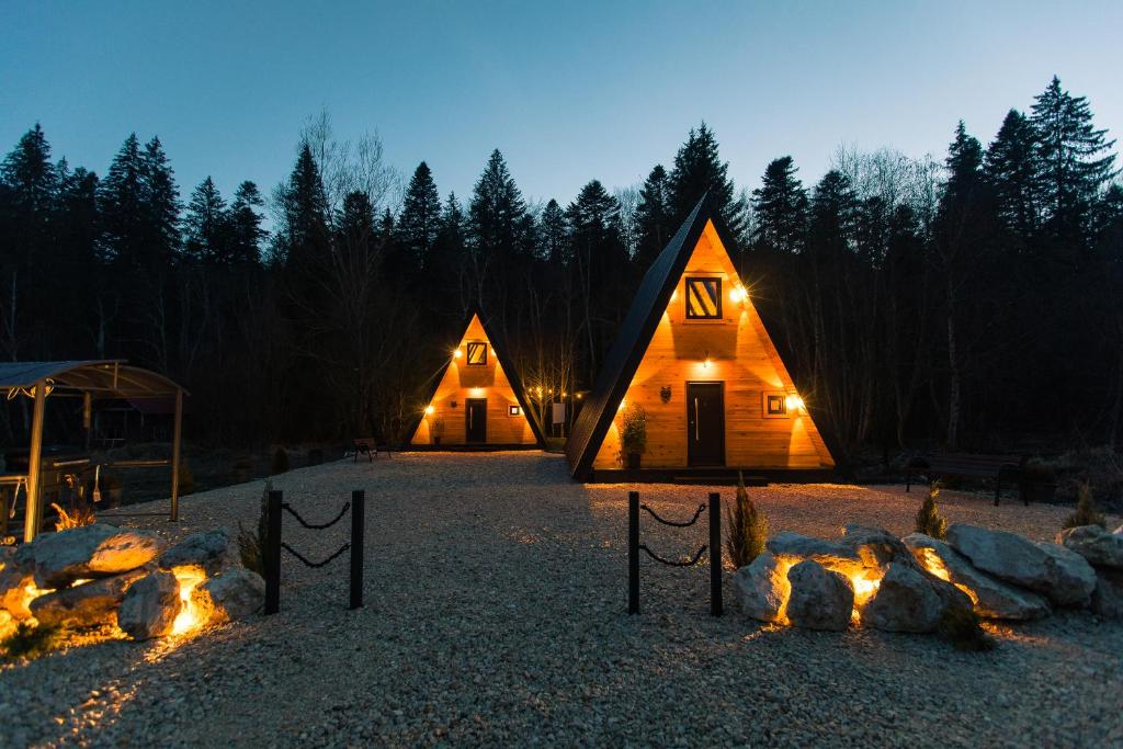 a couple of large wooden homes at night at The Palo Cabins in Predeal