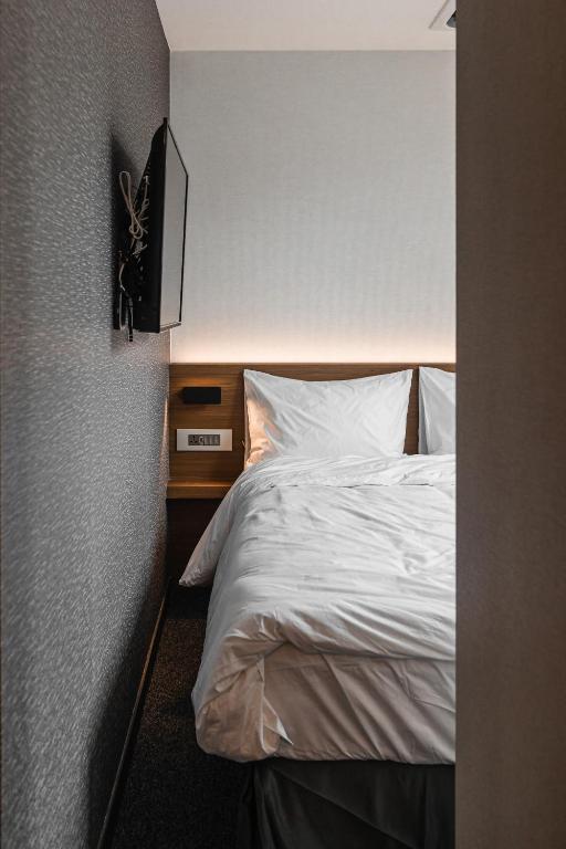 Cama ou camas em um quarto em Pillowsopher Hongdae