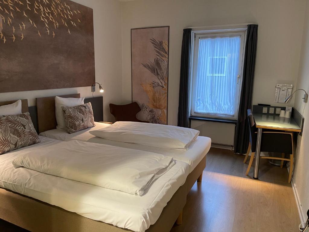 Postel nebo postele na pokoji v ubytování City Hotel Nattergalen