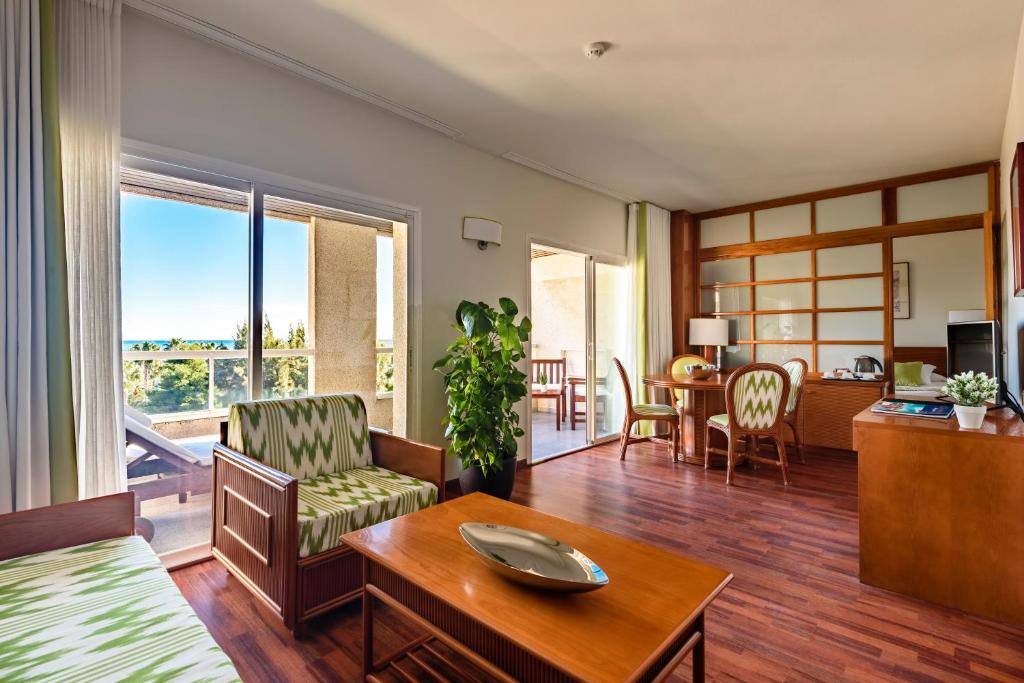 a living room with a couch and a table at Estival Park Silmar in La Pineda