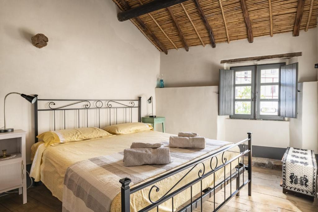 a bedroom with a large bed with two towels on it at Un gioiello in centro storico in Bari Sardo