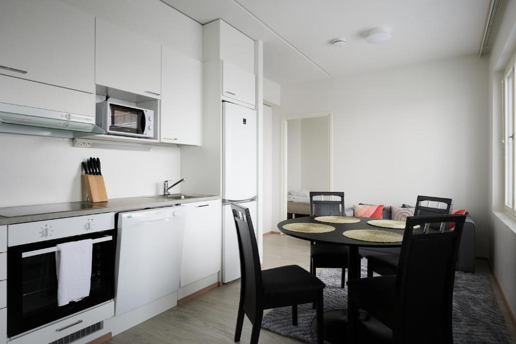 une cuisine avec une table et des chaises dans l'établissement New apartment, two bed room, free car park, à Turku