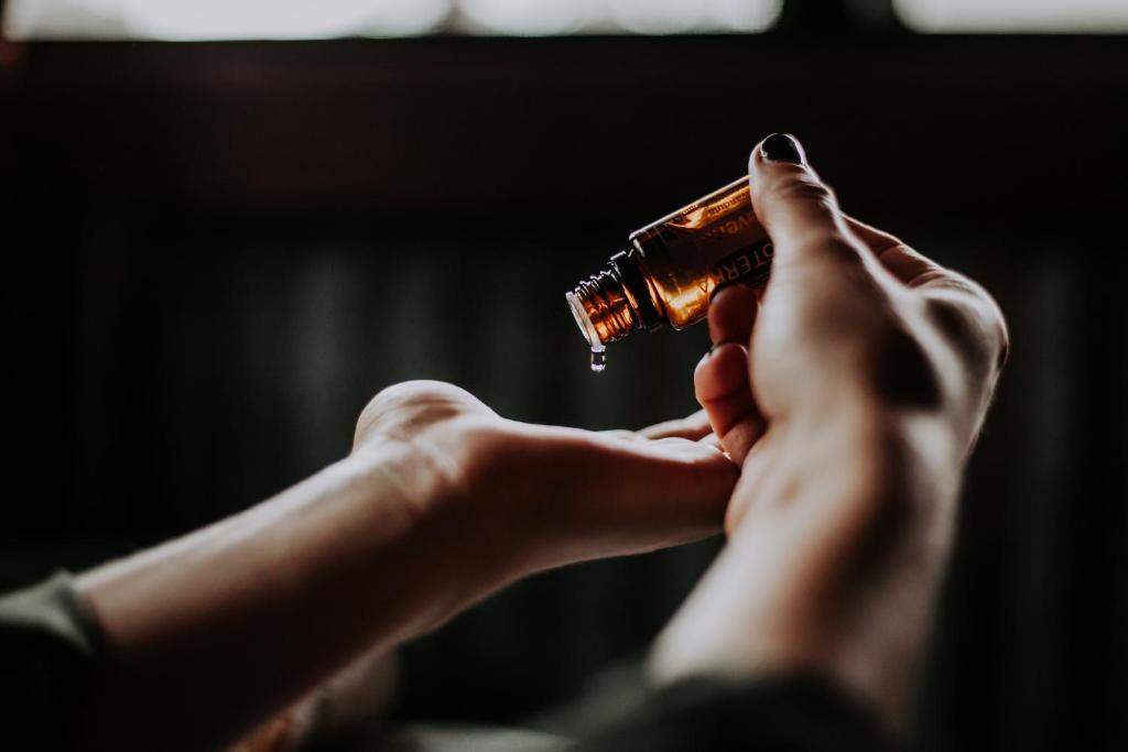 a person holding a bottle with their hands at Dukley Hotel & Resort in Budva