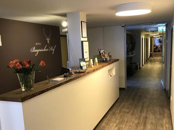 eine Lobby mit einer Theke mit Blumen darauf in der Unterkunft Bayrischer Hof in Krefeld