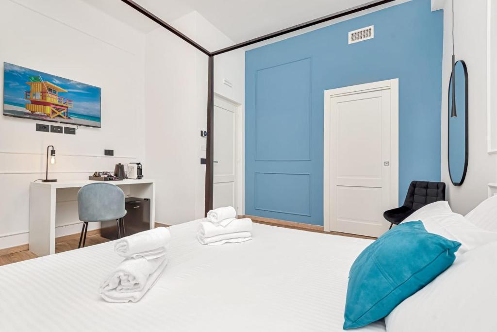 Posteľ alebo postele v izbe v ubytovaní Nelli Rooms Via Biassa