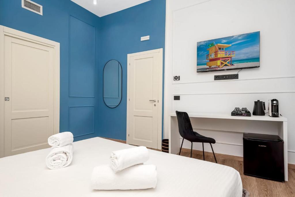 Posteľ alebo postele v izbe v ubytovaní Nelli Rooms Via Biassa