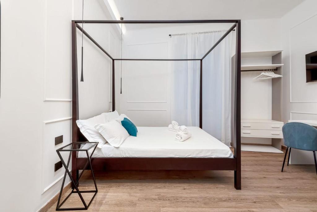 Posteľ alebo postele v izbe v ubytovaní Nelli Rooms Via Biassa
