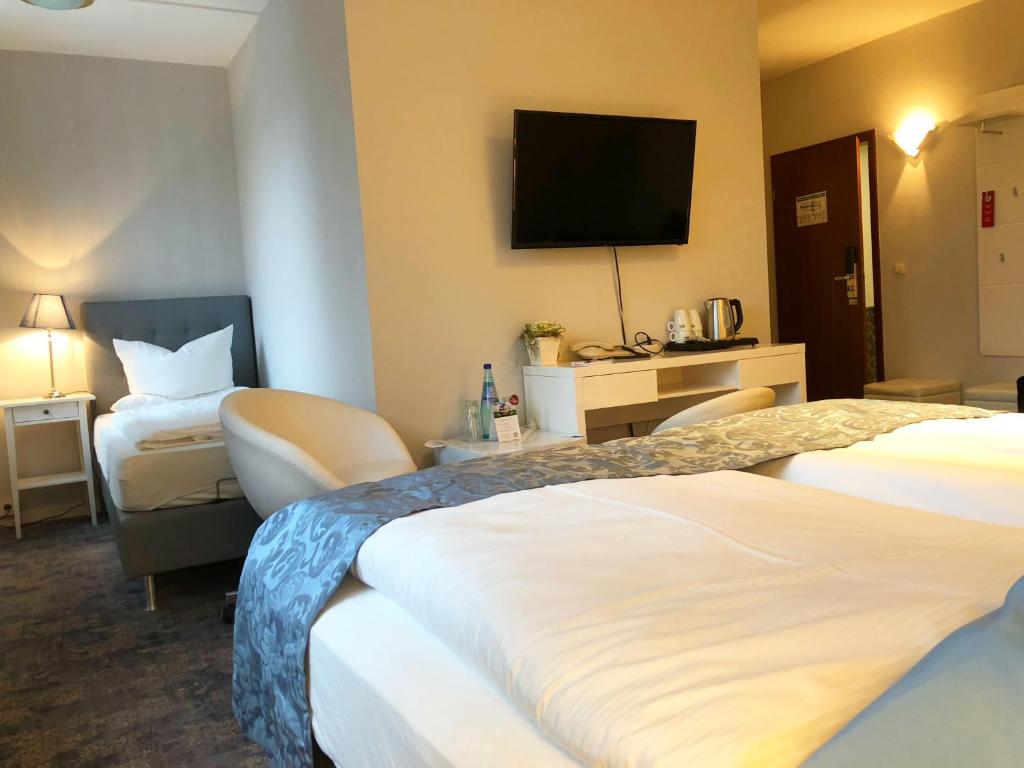 Postel nebo postele na pokoji v ubytování Hotel Kristall