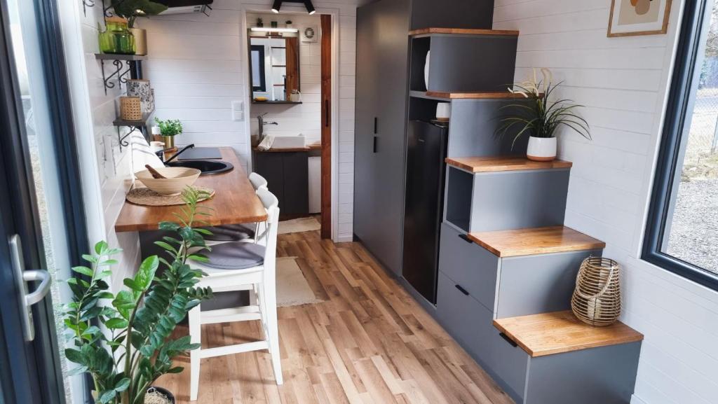 a tiny house with a kitchen and a desk at Forest House Augustów in Augustów
