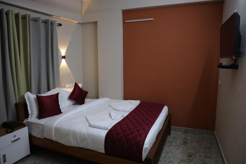 Postel nebo postele na pokoji v ubytování Dreams Paradise Airport Residency