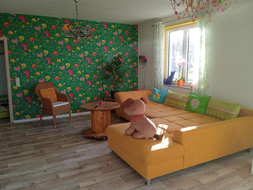 a teddy bear sitting on a couch in a living room at Gartenlaube in Thale