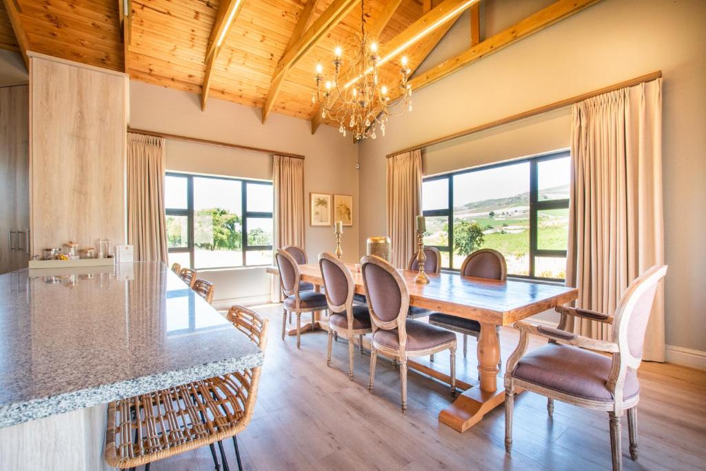 a dining room with a table and chairs at Eikenhof Estate in Brackenfell