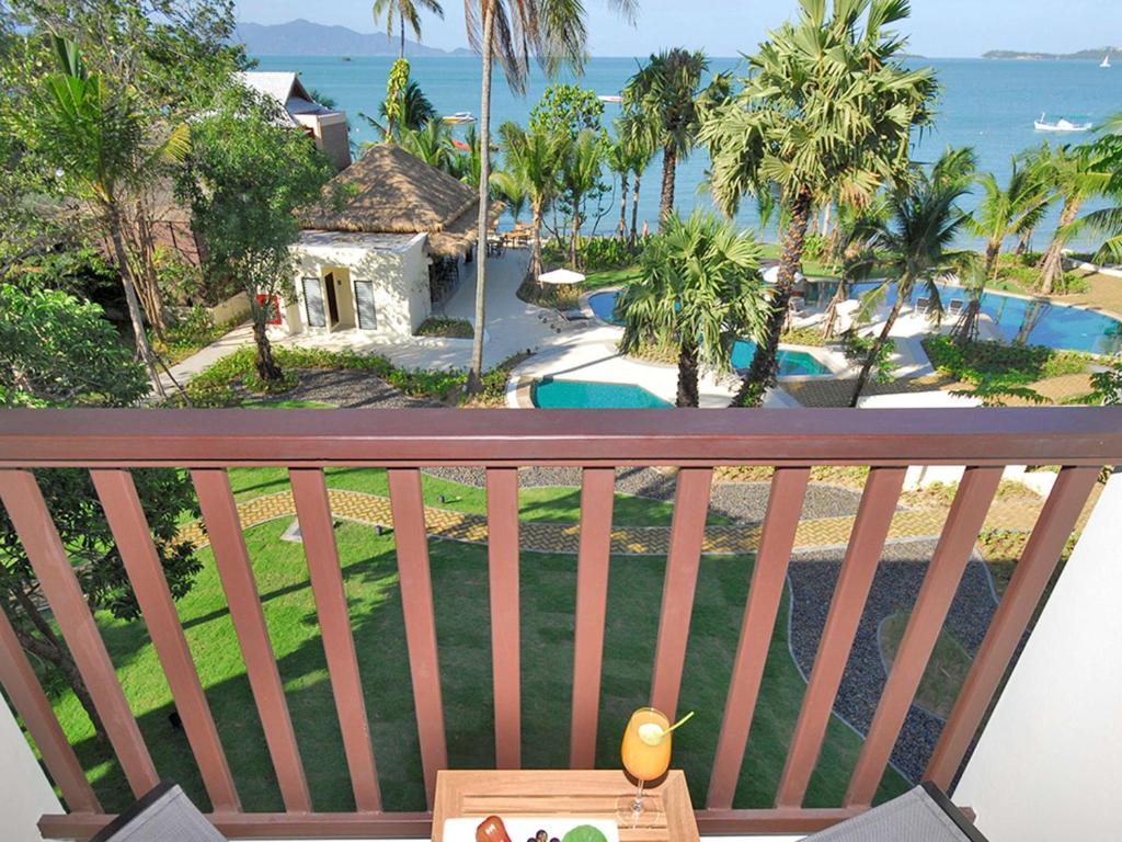 a view of the ocean from the balcony of a resort at Hotel Ibis Samui Bophut in Bophut