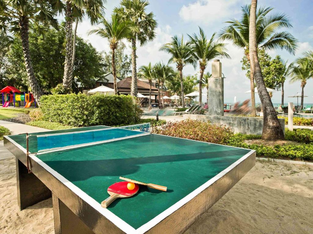 a ping pong table in a park with palm trees at Hotel Ibis Samui Bophut in Bophut