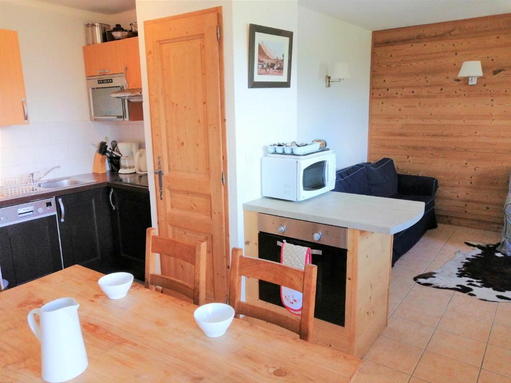 a kitchen with a microwave on top of a counter at Appartement Morillon 1100, 3 pièces, 6 personnes - FR-1-412-5 in Morillon