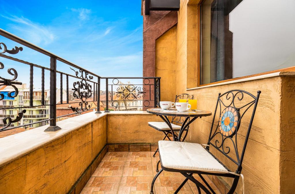 - un balcon avec une table et des chaises dans l'établissement The Walnut 2BD Apartment, à Plovdiv