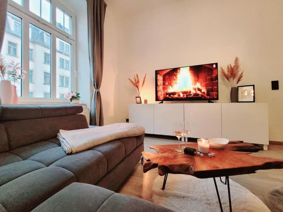 ein Wohnzimmer mit einem Sofa und einem TV in der Unterkunft Daheim in Dresden in Dresden