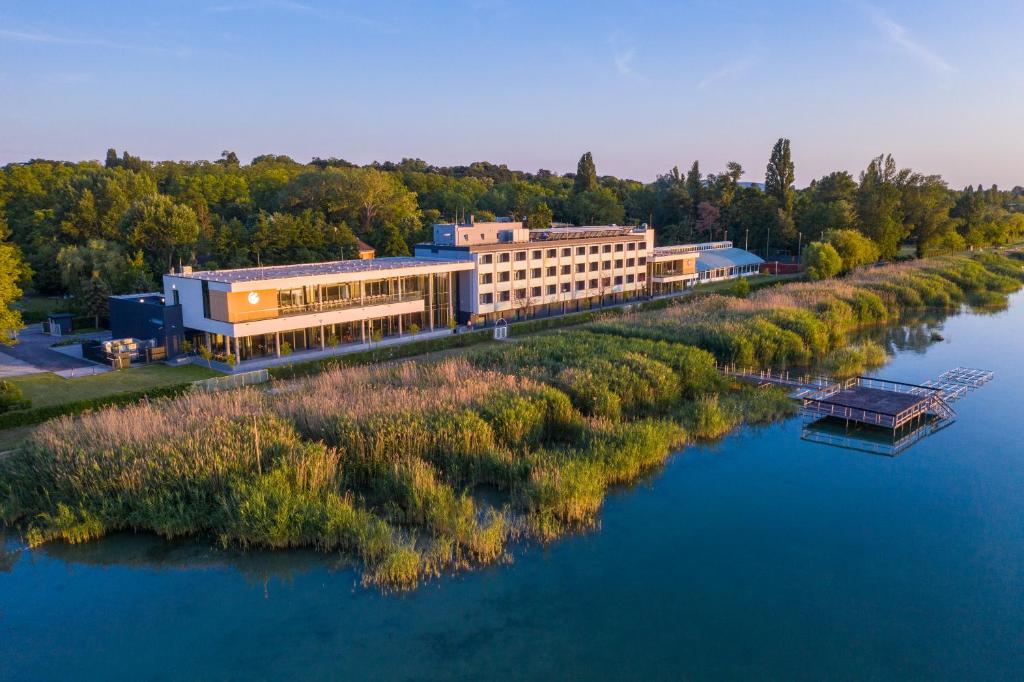 an aerial view of a building next to a river at Hotel OTP Balatonszemes in Balatonszemes