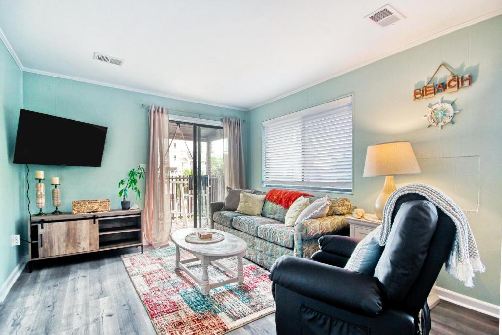 ein Wohnzimmer mit einem Sofa und einem TV in der Unterkunft North Myrtle Hideaway in Myrtle Beach