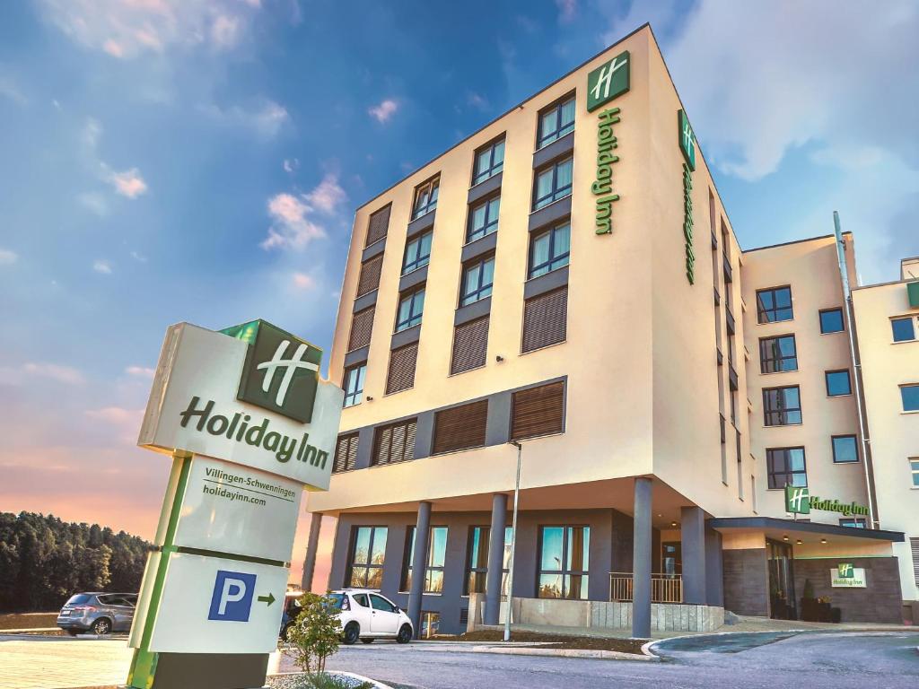 a hotel building with a sign in front of it at Holiday Inn - Villingen - Schwenningen, an IHG Hotel in Villingen-Schwenningen