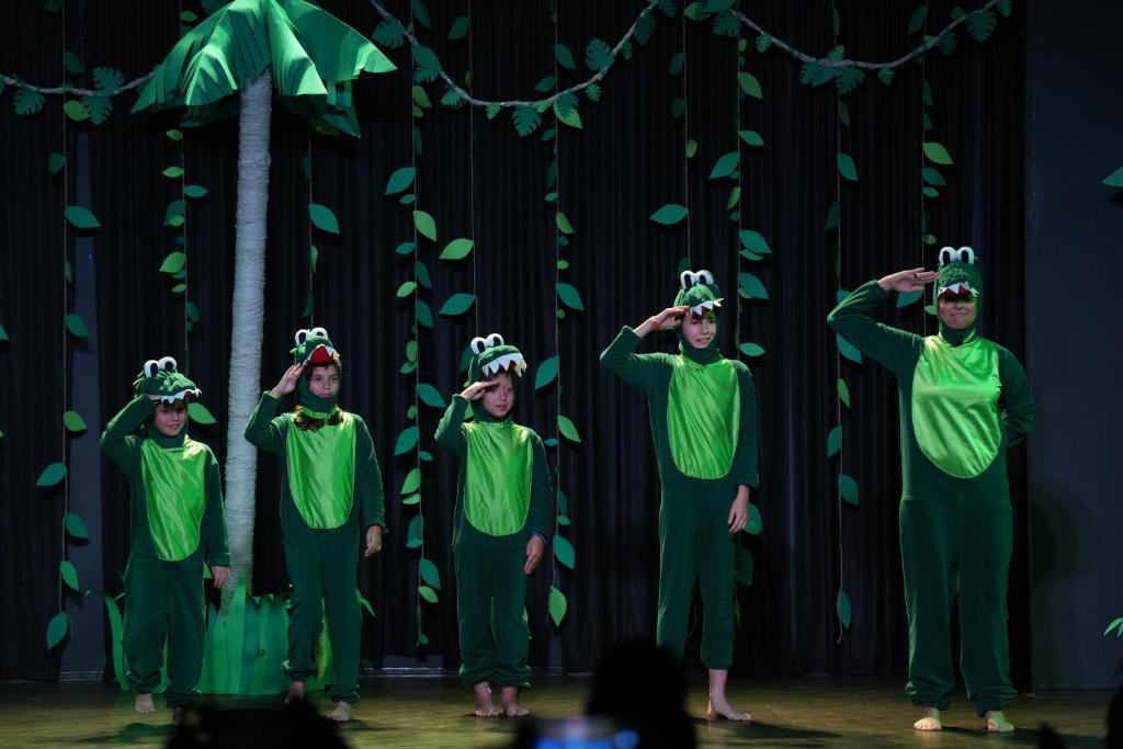 a group of people in green costumes on a stage at HVD Reina del Mar - Premium Spa Service & Free Parking in Obzor