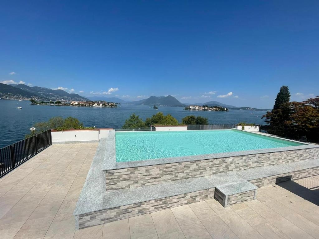 a swimming pool with a view of the water at Isole in Baveno