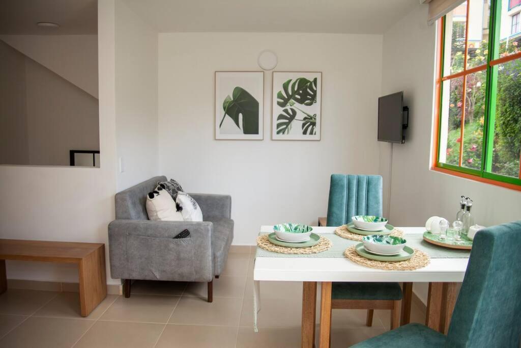 a dining room with a table and a chair at Duplex Familiar Apartment Nature in Guatapé
