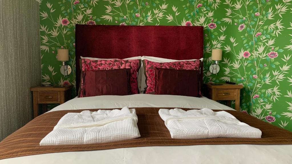 a bed with two white towels on top of it at Ramsey House - Luxury Licensed B&B - Parking and Guest Lounge in St. Davids