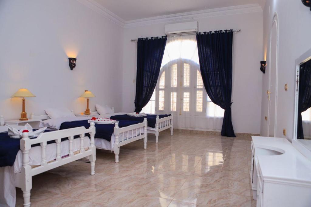 Postel nebo postele na pokoji v ubytování Luxor Oasis Guest House