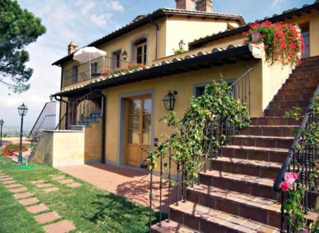 a house with a staircase leading up to it at Appartamento Frantoio in San Miniato