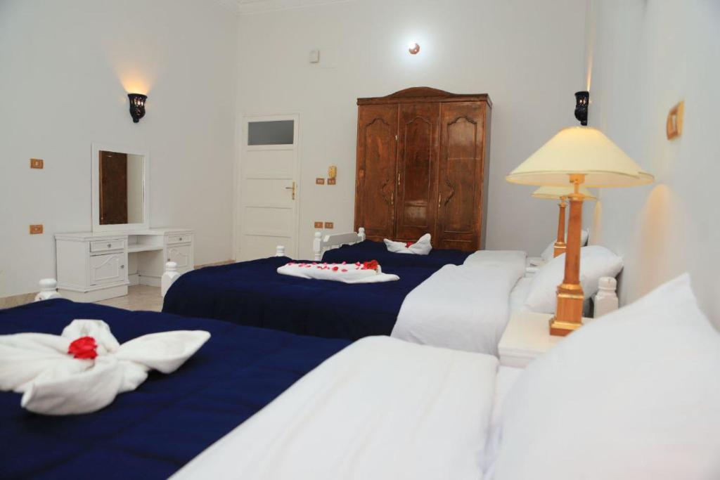 Postel nebo postele na pokoji v ubytování Luxor Oasis Guest House
