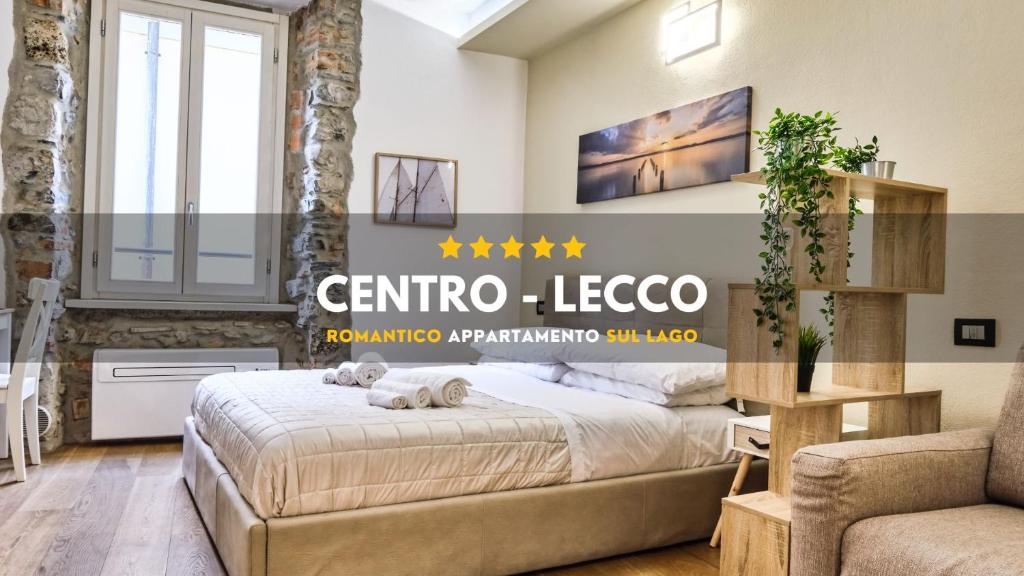 a bedroom with a bed with a dog laying on it at [CENTRO-LECCO] Romantico Appartamento sul Lago in Lecco