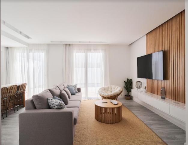 A television and/or entertainment centre at 3bedroom apartment with a private pool