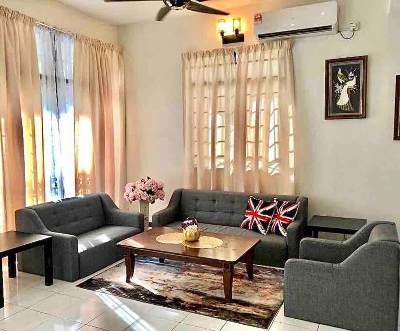 a living room with two couches and a coffee table at SUPER COMFY HOME @ KULIM CITY in Kulim
