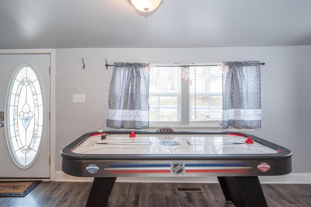 a room with a pool table in front of a window at Blue Mountain Bungalow 