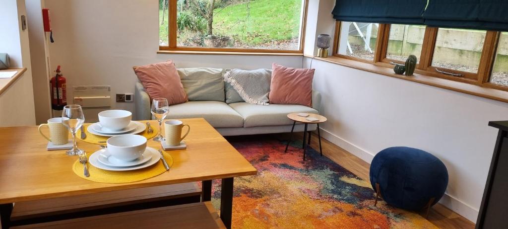 a living room with a table and a couch at The Glasshouse in Ilfracombe
