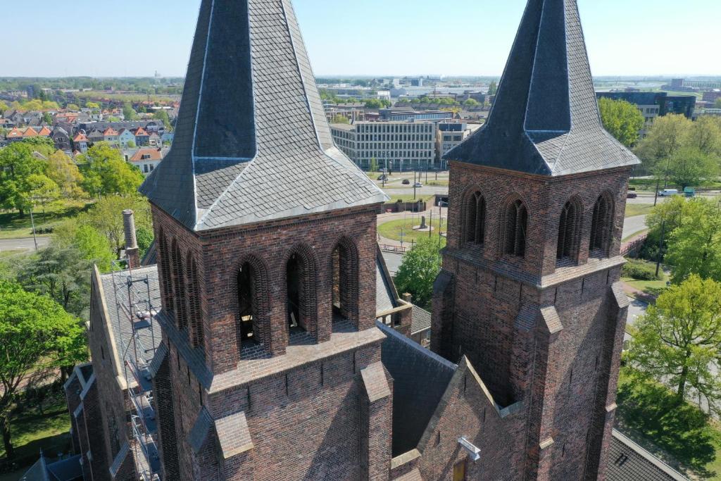 an aerial view of a church with two towers at Walburgis Residenties in Arnhem