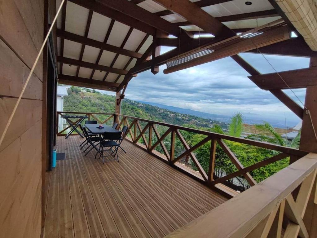 a balcony of a house with a table and chairs at Chalet Iris in Le Lambert