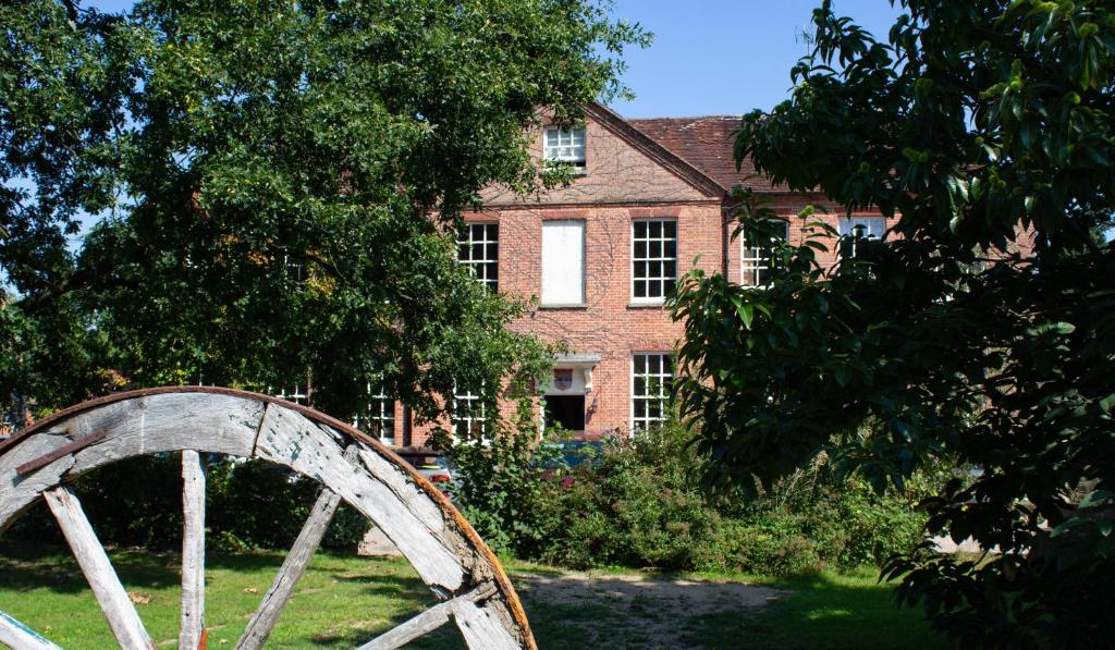 a house with a brick building and a wooden bridge at Trading Boundaries in Uckfield