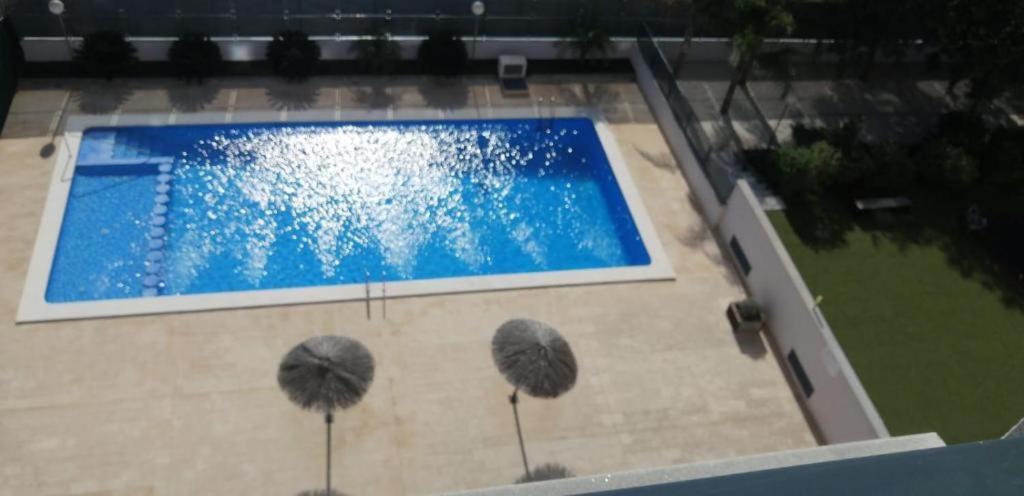 an overhead view of a swimming pool in a building at Apartamento DALÍ in Murcia