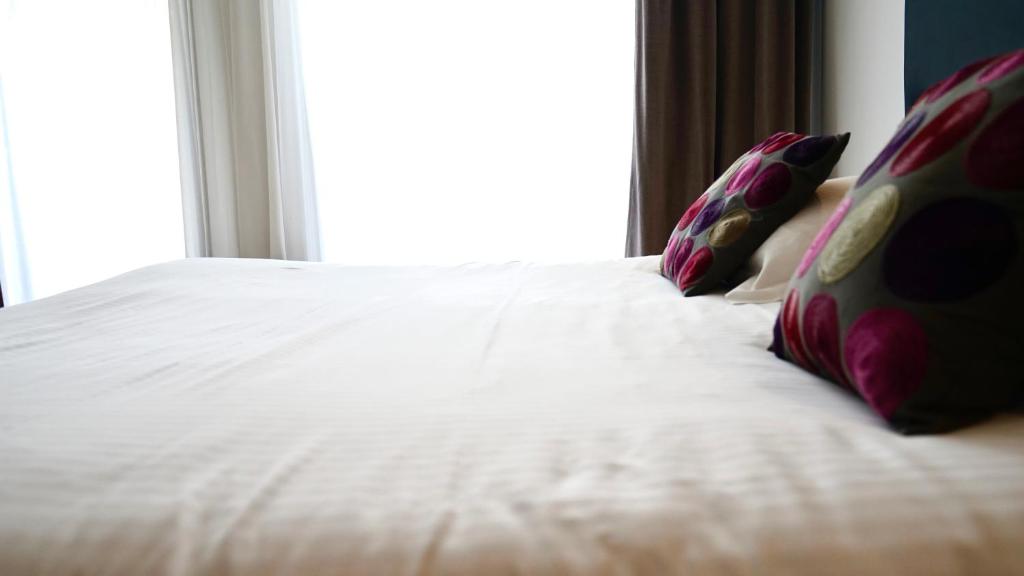 Postel nebo postele na pokoji v ubytování Boutique Logis Hôtel Relais de Vincey