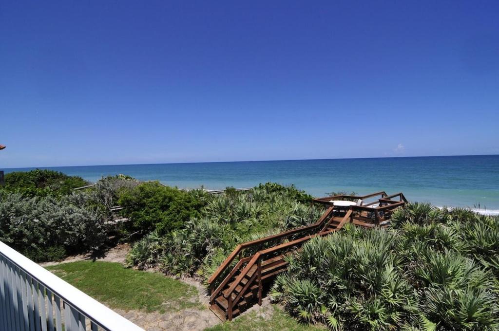 een trap naar het strand bij Pelican Perch-Four bedroom heated pool oceanfront home in Melbourne Beach