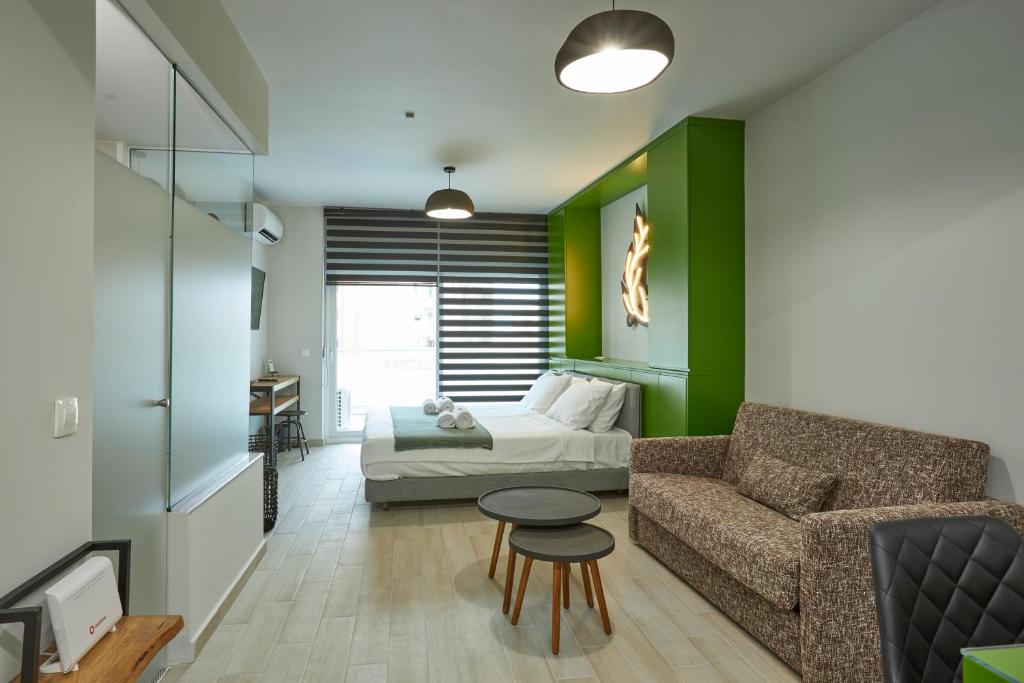 a living room with a bed and a couch and a table at Olea Apartments in Thessaloniki
