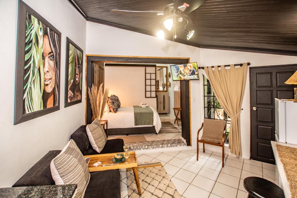 a living room with a bedroom and a bed at Hello Sunshine Self Catering Studio Apartments in Nelspruit