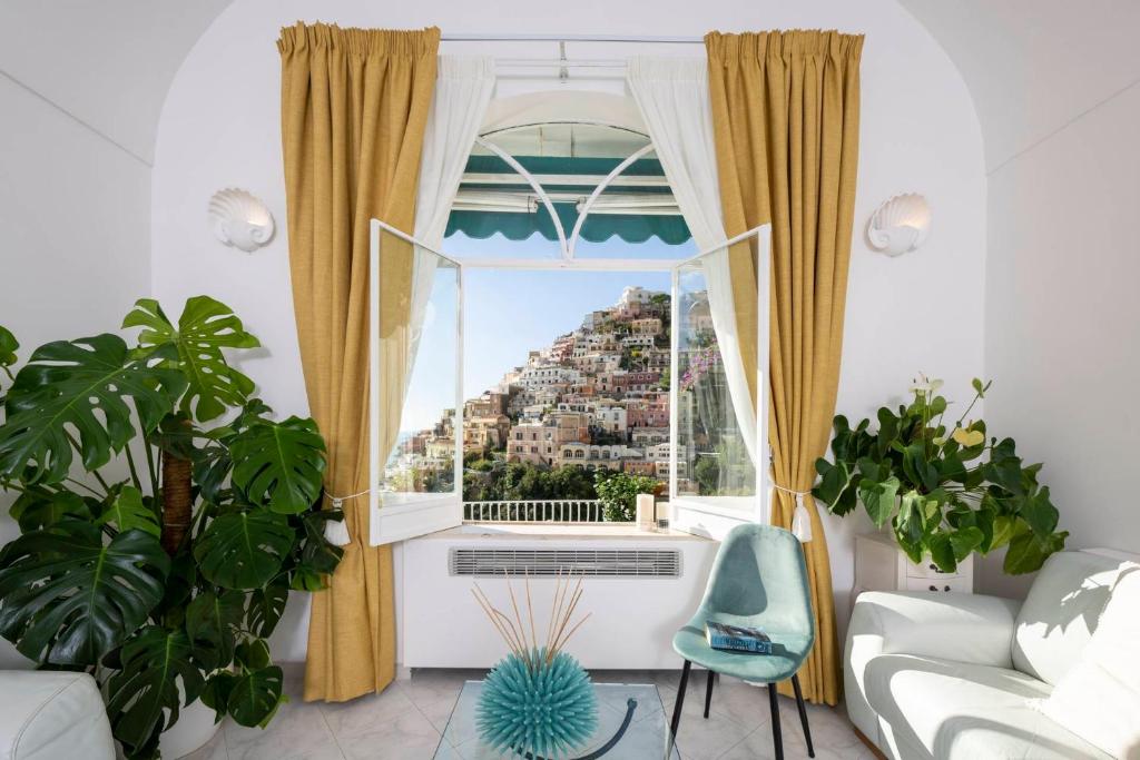 a living room with a window with a view of a city at Villa Dalu in Positano