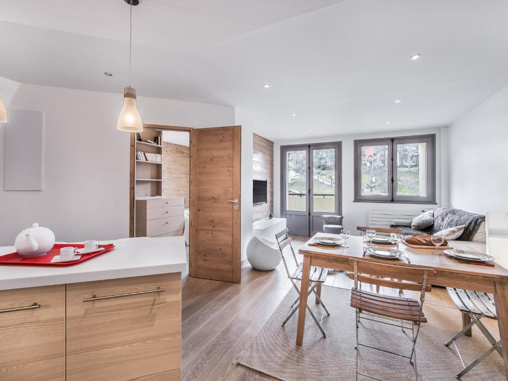 a kitchen and living room with a table and chairs at Appartement 3 pièces au centre de Megève, balcon, proche télécabine, Wifi, idéal pour 4 personnes - FR-1-453-53 in Megève