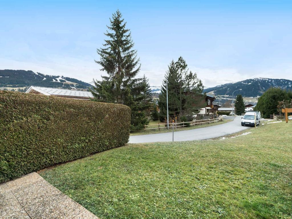 a hedge in front of a street with a car on the road at Appartement Megève, 2 pièces, 4 personnes - FR-1-453-63 in Megève