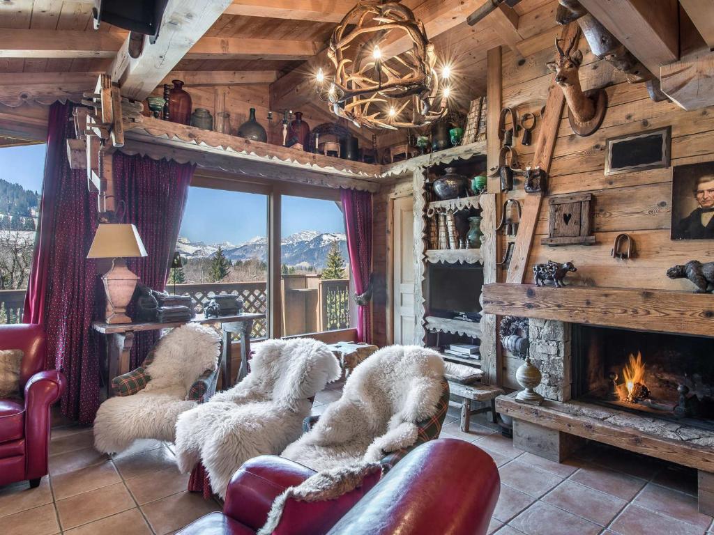 a living room with couches and a fireplace at Appartement Megève, 5 pièces, 8 personnes - FR-1-453-28 in Megève