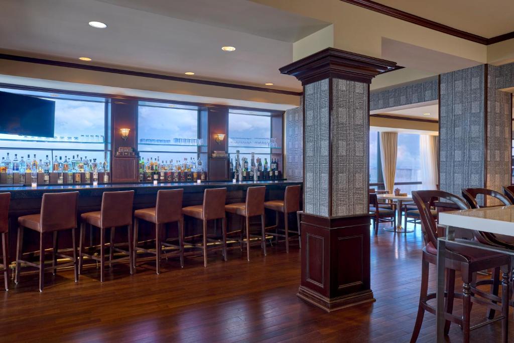 a bar in a restaurant with a view of the ocean at Omni New Haven Hotel at Yale in New Haven
